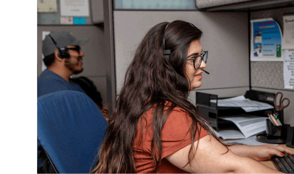 image of woman sitting at desk with headset