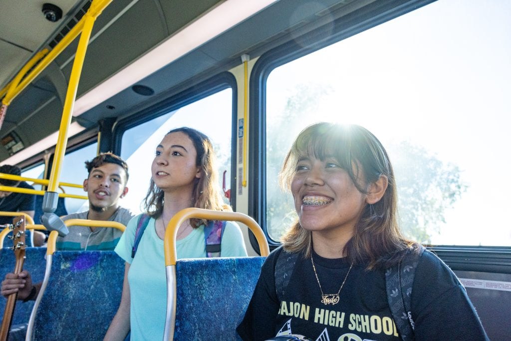 Girl smiling sitting on Omnitrans bus