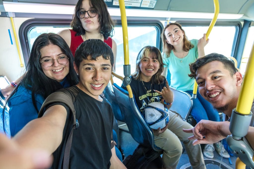 Students taking a selfie on Omnitrans bus.